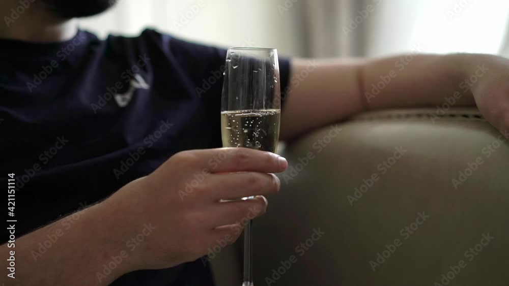Man sitting with glass of champagne. High quality FullHD footage Man sitting with glass of champagne. High quality FullHD footage