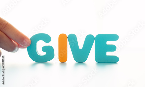 Obraz na plátně Kid hand holding GIVE word for give opportunity, charity, giving tuesday, Business CSR, Support, Donation for poor people