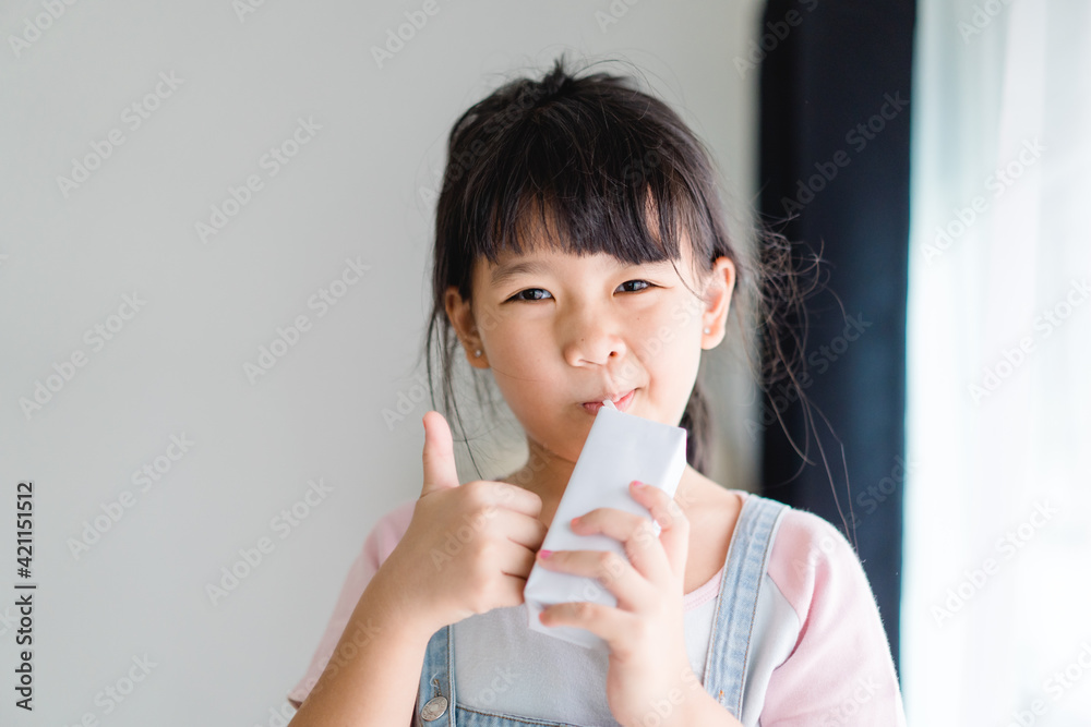 Organic lactose free milk.Asian kid girl drinking milk.Calcium vitamin from milk.Grocery, Good taste.Kid drink.School kid girl, Healthy, yoghurt, mock up product.Delicious tasty.Fruit juice.vitamin C. Organic lactose free milk.Asian kid girl drinking milk.Calcium vitamin from milk.Grocery, Good taste.Kid drink.School kid girl, Healthy, yoghurt, mock up product.Delicious tasty.Fruit juice.vitamin C.