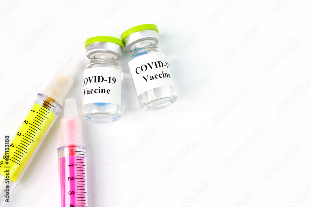 Covid-19 bottle vaccination and syringe isolated on a white background Covid-19 bottle vaccination and syringe isolated on a white background