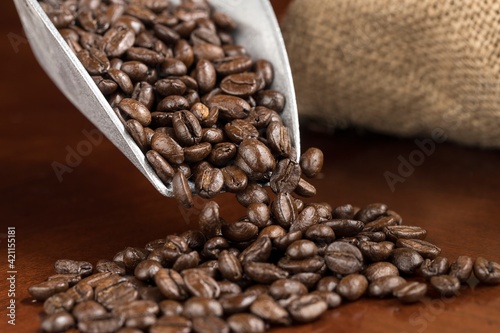 A studio concept photo of pouring coffee beans into a pile.