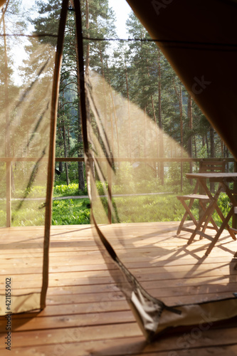 View from the glamping tent on the table and chairs on the terrace © avtk