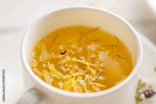 cup of aromatic flower tea, soothing, medicinal, antipyretic close-up