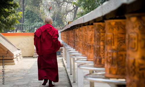 A monk with prayer wheels in a Bhuddisht temple © mukulmathur85