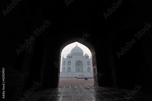 view of taj mahal from an marble arch frame.