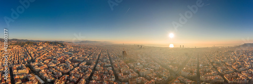 360 aerial panorama drone shot of skyline in Barcelona city center in foggy sunrise golden hour in Spain winter