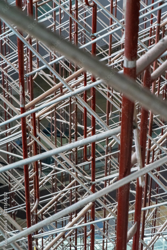 Blurry photo of the scaffolding providing platforms. work in progress on a building under construction with scaffolds. Construction Site of New Building Blurry photo of the scaffolding providing platforms. work in progress on a building under construction with scaffolds. Construction Site of New Building