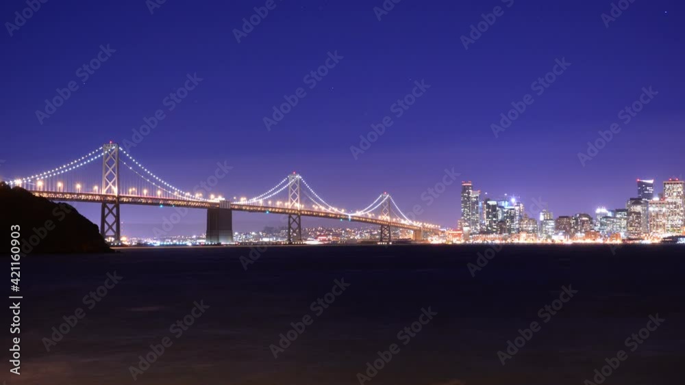 San Francisco Bay Bridge from Treasure Island Time Lapse Night Traffic Pan Right California USA