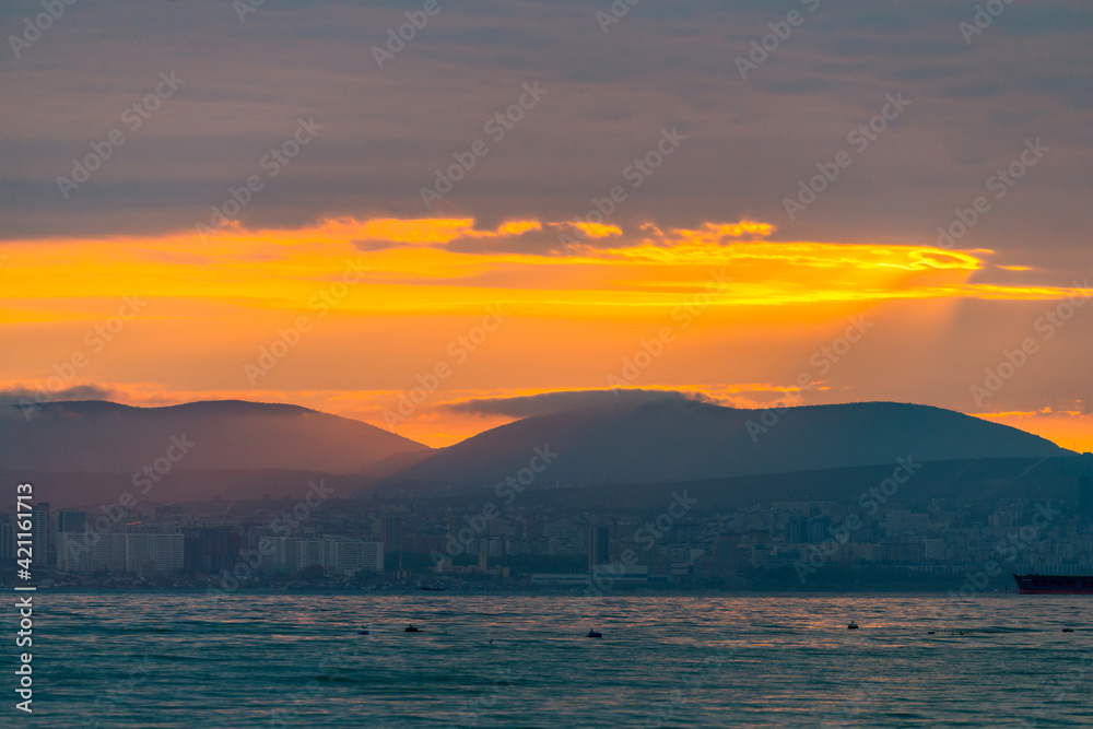 City ona a coast of sea on sunset