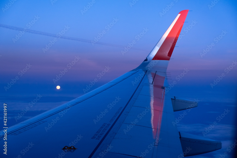 Fototapeta premium Beautiful sunset, airplane flying view from inside window aircraft of Traveling