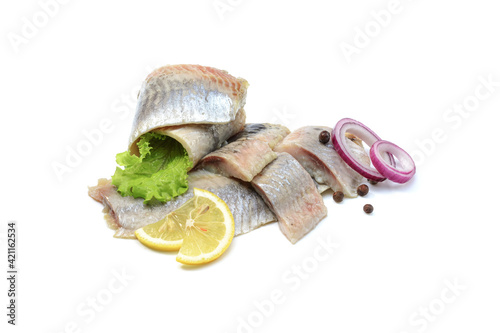 Atlantic salted herring fillet with onion ring,lemon, and pepper, isolated on a white background photo