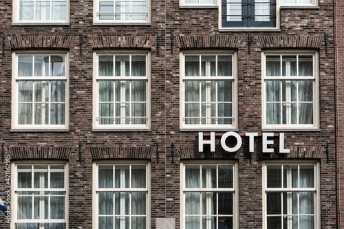 Hotel sign mounted on brick facade