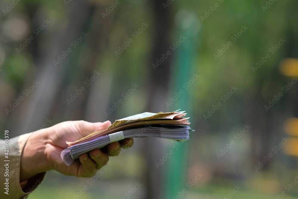 Hand holding banknote money and saving money and business growth concept, Finance and investment concept Hand holding banknote money and saving money and business growth concept, Finance and investment concept