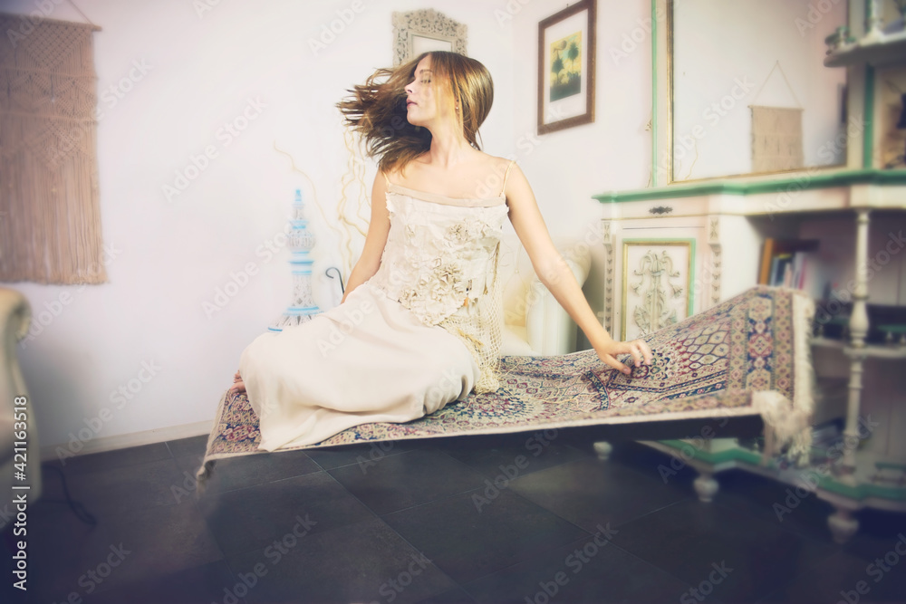 A girl 16 y old is levitating on carpet and dreaming. A girl 16 y old is levitating on carpet and dreaming.