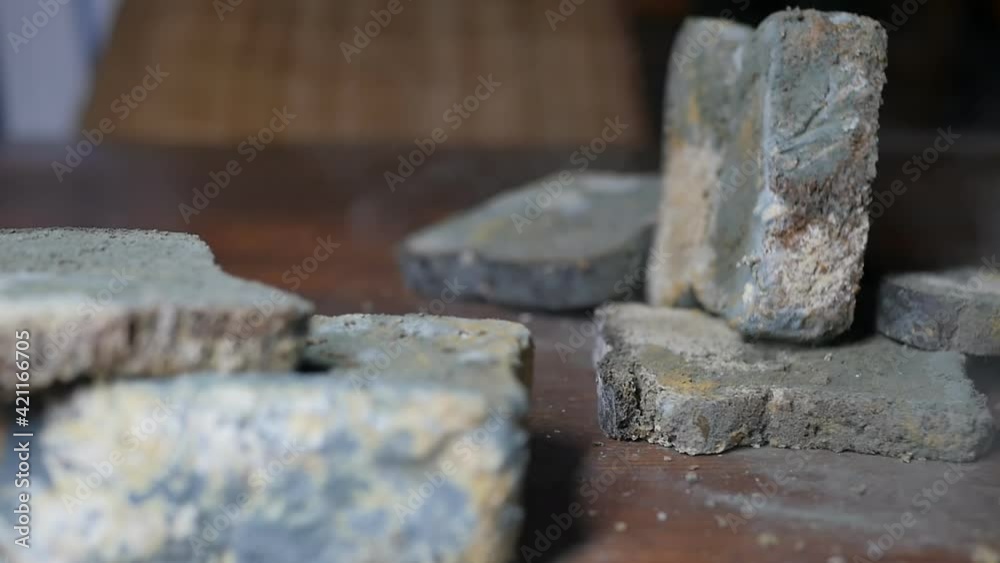 Slow motion. Slices of moldy bread falling on a wooden table. Bread crumbs dust from mold flies to the sides Slow motion. Slices of moldy bread falling on a wooden table. Bread crumbs dust from mold flies to the sides