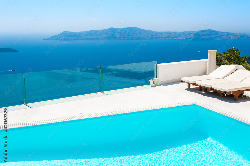 Santorini island, Greece. Luxury swimming pool with sea view. Famous travel destination