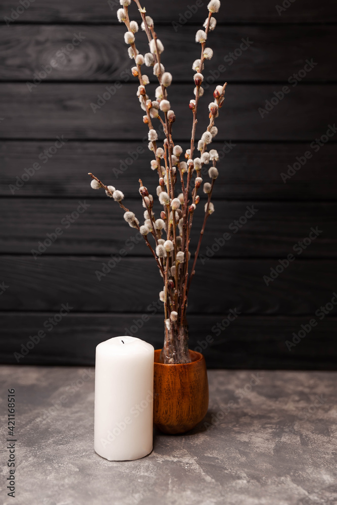 Vase with willow branches on dark background. Natural rustic morning. Beautiful home decor in spring, copy space. Fresh fluffy willow twigs in vase. Classic still life of low-key lighting, minimal art