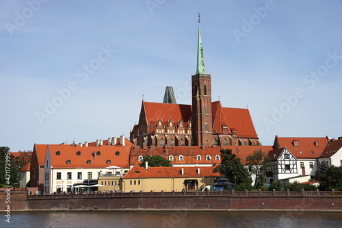 Wroclaw Church of the Holy Cross behind Oder River view, popular tourist destination, guided tour concept