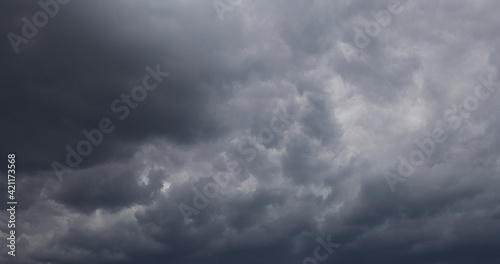 Dramatic cumulonimbus stormy clouds over city of