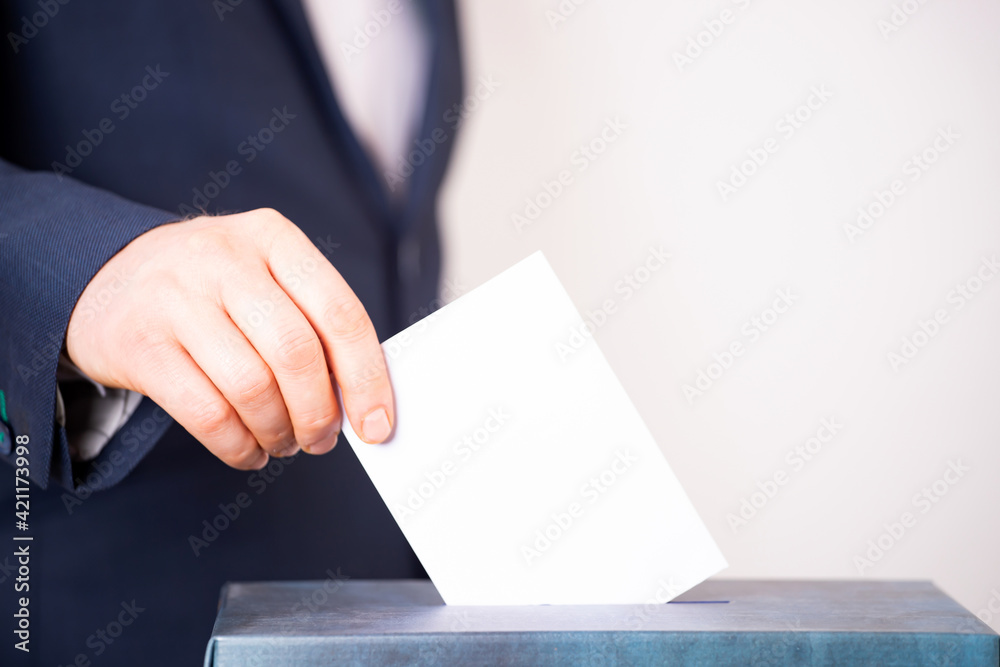 Voter Putting Ballot Into Voting box.