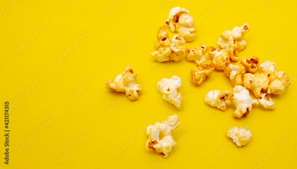 Close-up of popcorn on a yellow background. Close-up of popcorn on a yellow background.