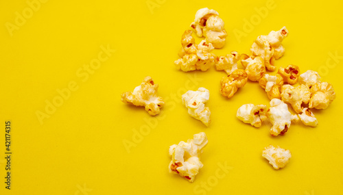 Close-up of popcorn on a yellow background.