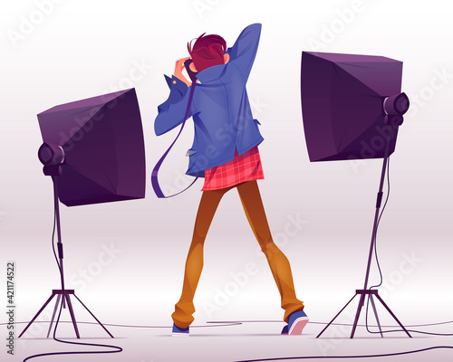 Photographer with camera take shots in studio