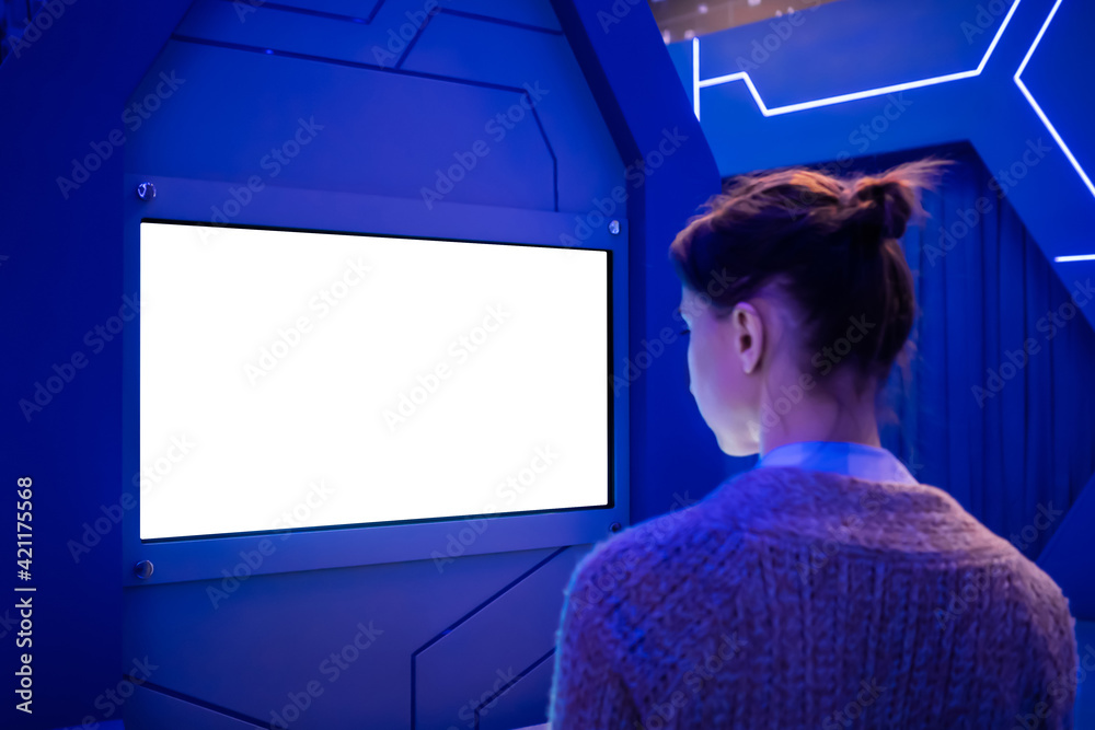 White screen, mock up, future, copyspace, template, technology concept. Woman looking at blank interactive touchscreen white display of electronic kiosk at futuristic exhibition or museum White screen, mock up, future, copyspace, template, technology concept. Woman looking at blank interactive touchscreen white display of electronic kiosk at futuristic exhibition or museum