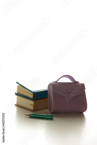 brief-case, two books and a pencil isolated on white background. Education concept