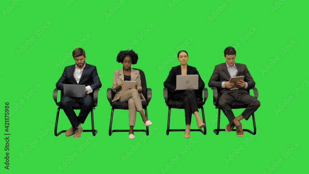 Business people at the conference listening and taking notes on their laptops on a Green Screen, Chroma Key.