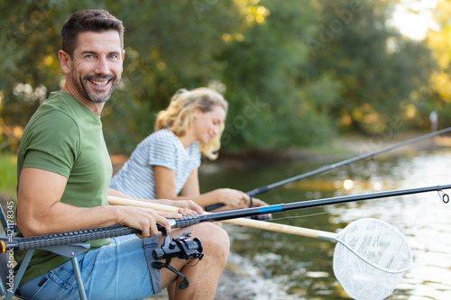 couple fishing in the river during summer vacation