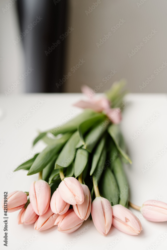 Blush pink tulips bouquet on white table Blush pink tulips bouquet on white table
