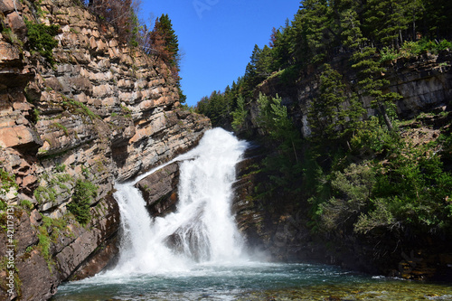 pretty cameron falls on a sunny summer day in the town of waterton  alberta  canada