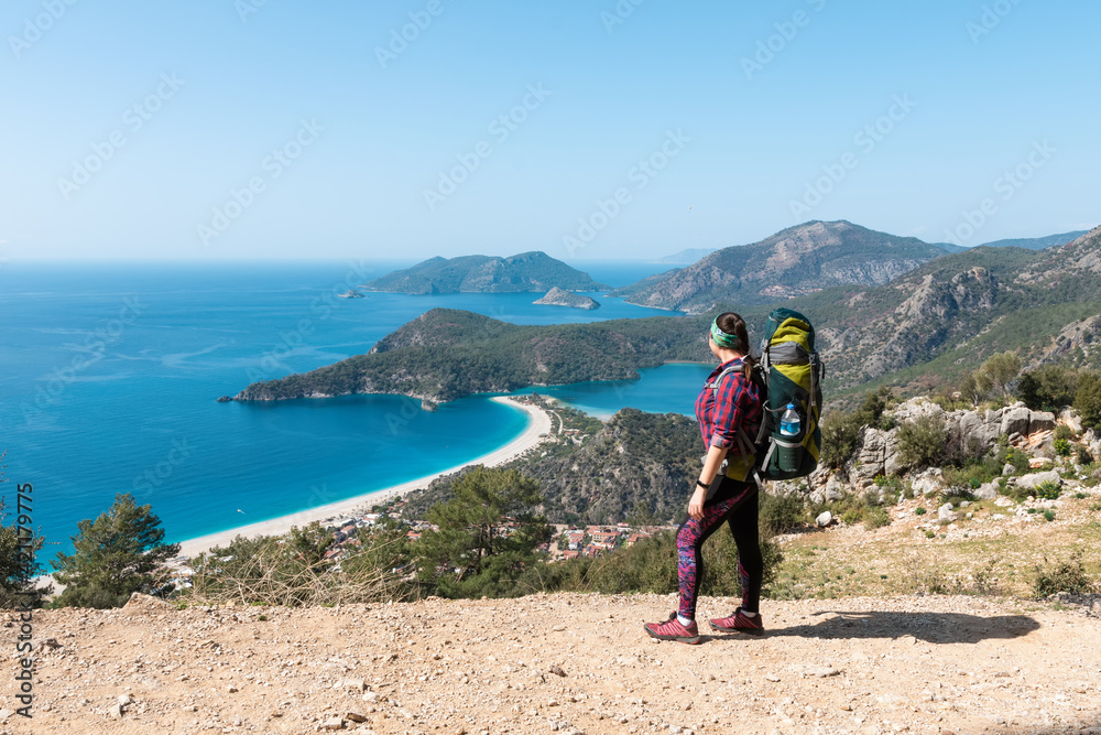 Hiker girl on the mountain top. Oludeniz, Turkey