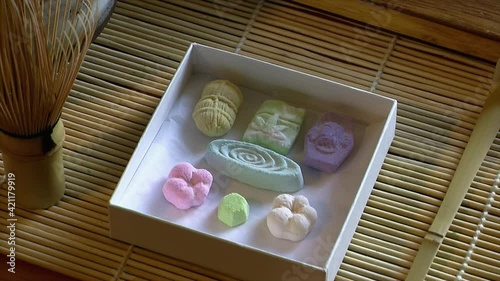 A box of Japanese rakugan tea sweets is opened. photo