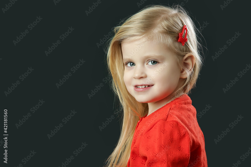 Studio portrait of beauiful blonde toddler girl in red cardigan Studio portrait of beauiful blonde toddler girl in red cardigan