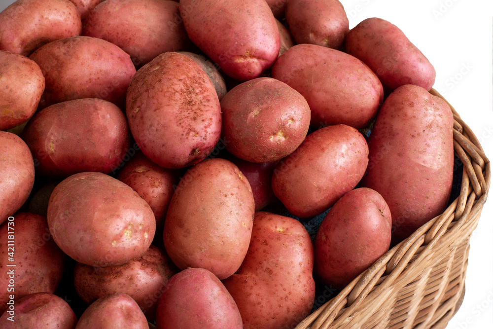 Basket with potatoes with red peel on a white background, isolate. Organic natural vegetables, farming Basket with potatoes with red peel on a white background, isolate. Organic natural vegetables, farming