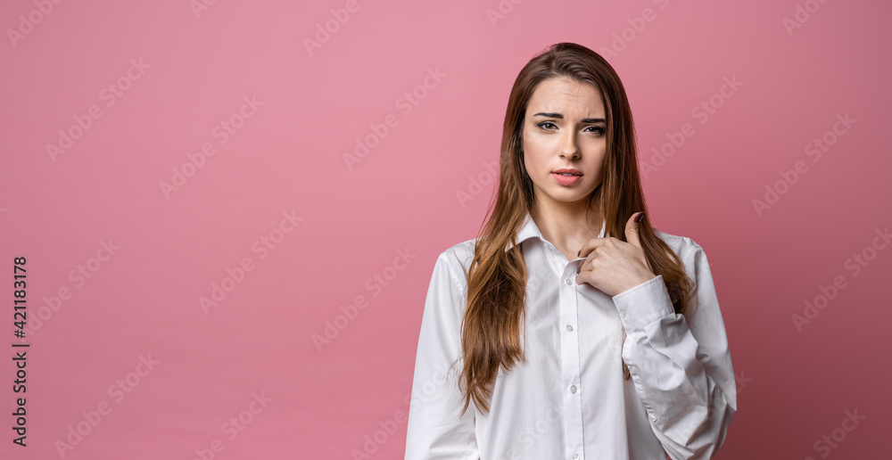 Surprised young brunette woman points to himself index finger, wonders why she was accused of what she didn't do Surprised young brunette woman points to himself index finger, wonders why she was accused of what she didn't do