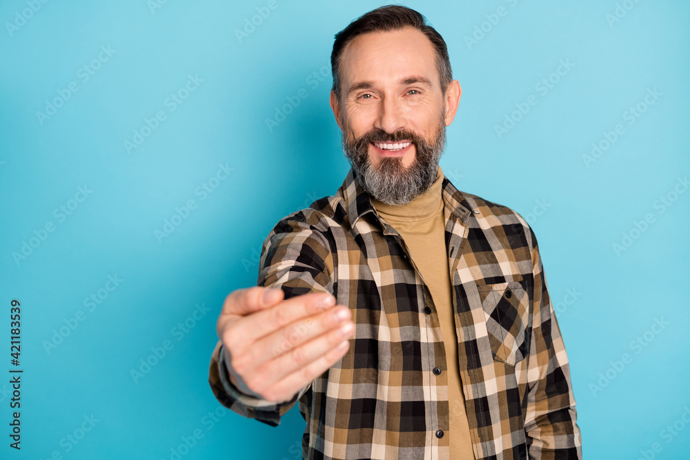 Photo portrait of aged man inviting smiling welcome to party isolated on vivid blue color background Photo portrait of aged man inviting smiling welcome to party isolated on vivid blue color background