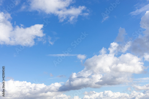 Detail of a white cloud in a bright blue sky. Dark rain clouds displace the blue sky. Storm is coming 