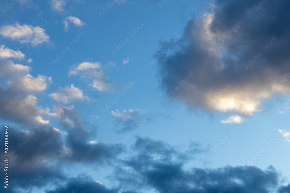 Detail of a white cloud in a bright blue sky. 
Dark rain clouds displace the blue sky. Storm is coming 
