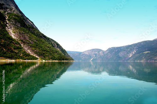  A fjord landscape in Norway, with water and mountains. Very blue sky 