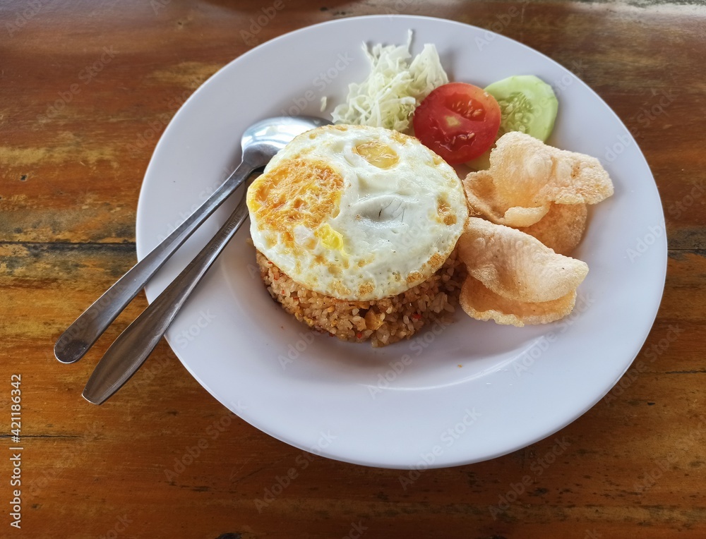 Table food. Egg fried rice on top, typical Indonesian food.