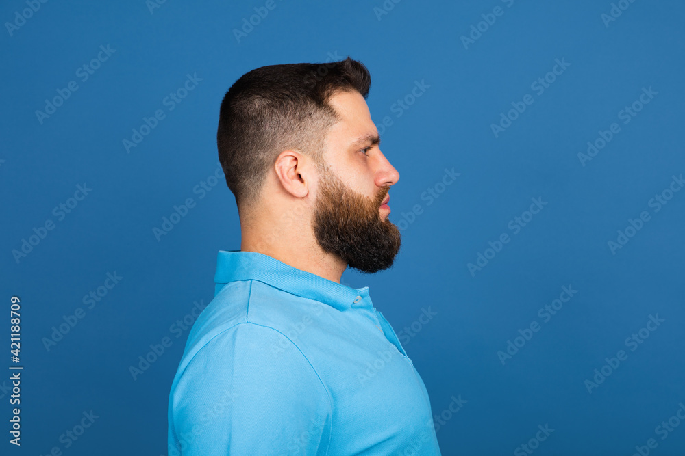 Caucasian man's portrait isolated on blue studio background with copyspace Caucasian man's portrait isolated on blue studio background with copyspace