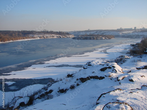Landscape of the water surface of the wide Dnieper bound by an ice shell and covered with a fluffy blanket of snow.