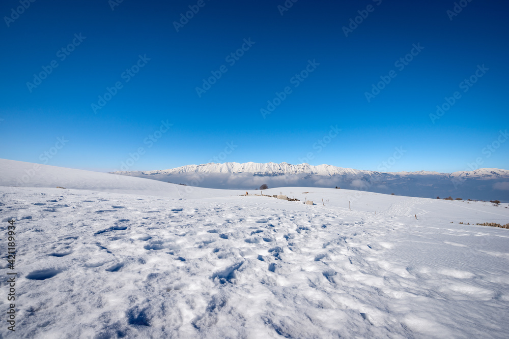 Mountain Range of Monte Baldo and Adamello in winter with snow,  view from the Lessinia Plateau (Altopiano della Lessinia) Verona. Veneto and Trentino Alto Adige, Italy, Europe.