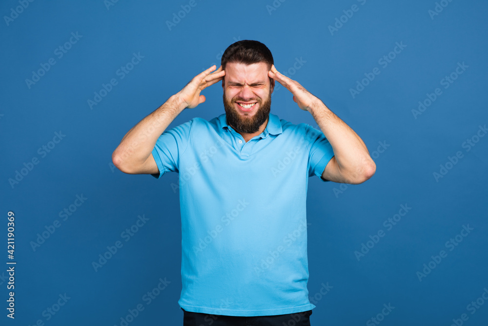 Caucasian man's portrait isolated on blue studio background with copyspace Caucasian man's portrait isolated on blue studio background with copyspace