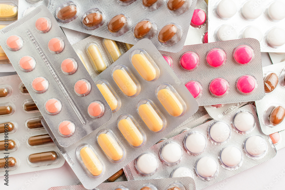 Close up of different medicine pills, tablets and vitamins isolated on white background, pharmaceutical picture taken with soft focus. Close up of different medicine pills, tablets and vitamins isolated on white background, pharmaceutical picture taken with soft focus.
