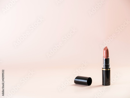 Open lipstick on a powdery background