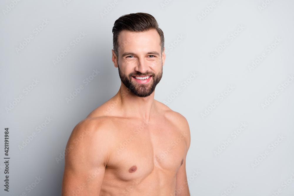Close-up portrait of attractive content cheerful perfect naked brunet guy posing isolated over light grey color background Close-up portrait of attractive content cheerful perfect naked brunet guy posing isolated over light grey color background